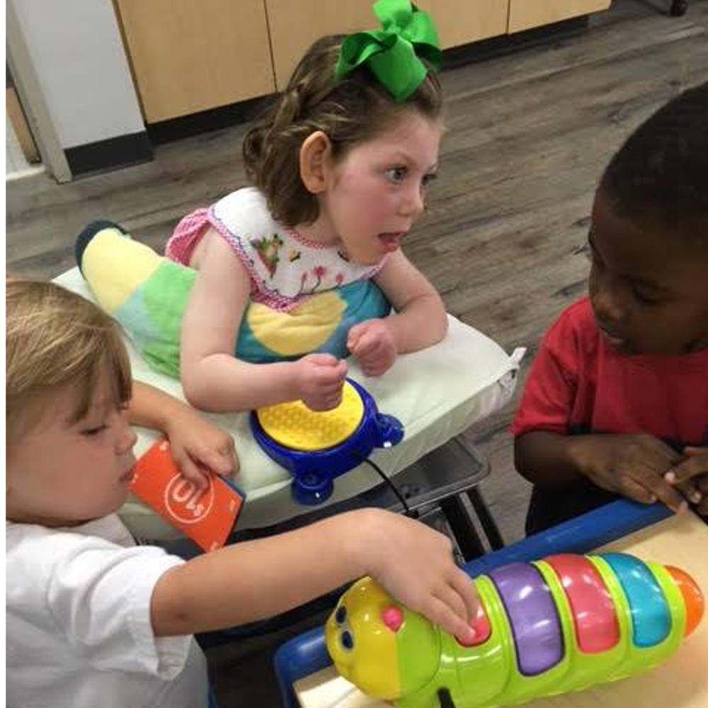 Group of United Ability children playing in classroom