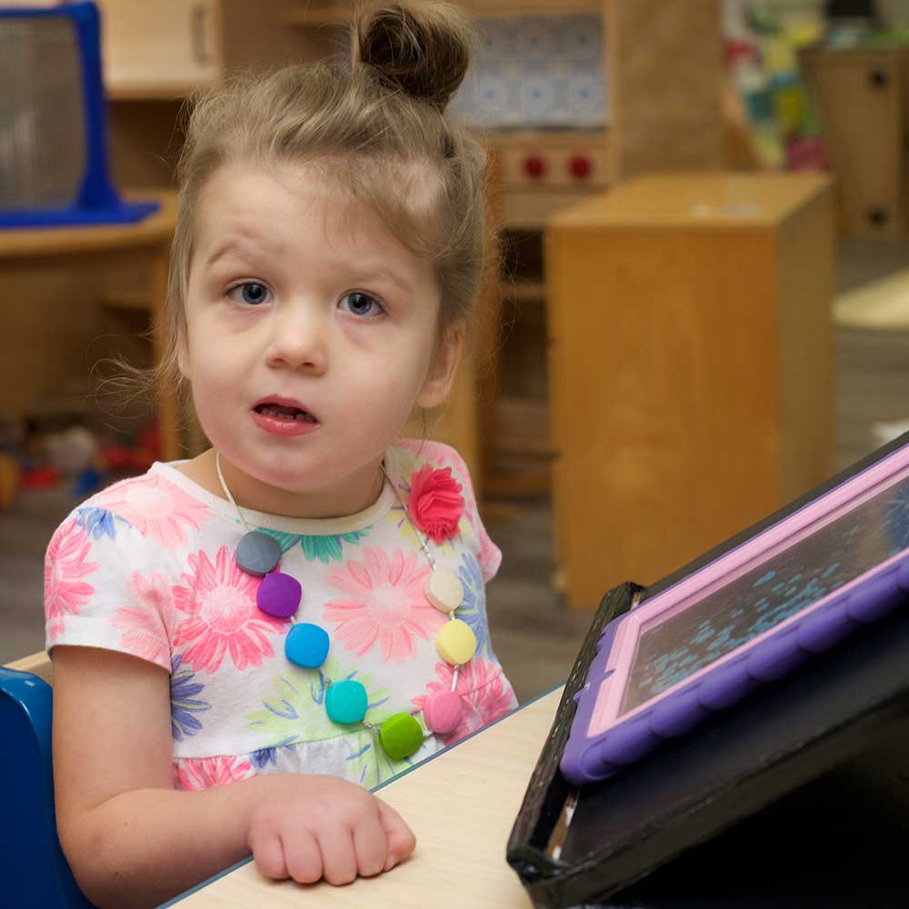 Young girl learning on ipad in the classroom