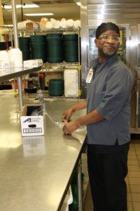 Man performing Food Services in a Kitchen