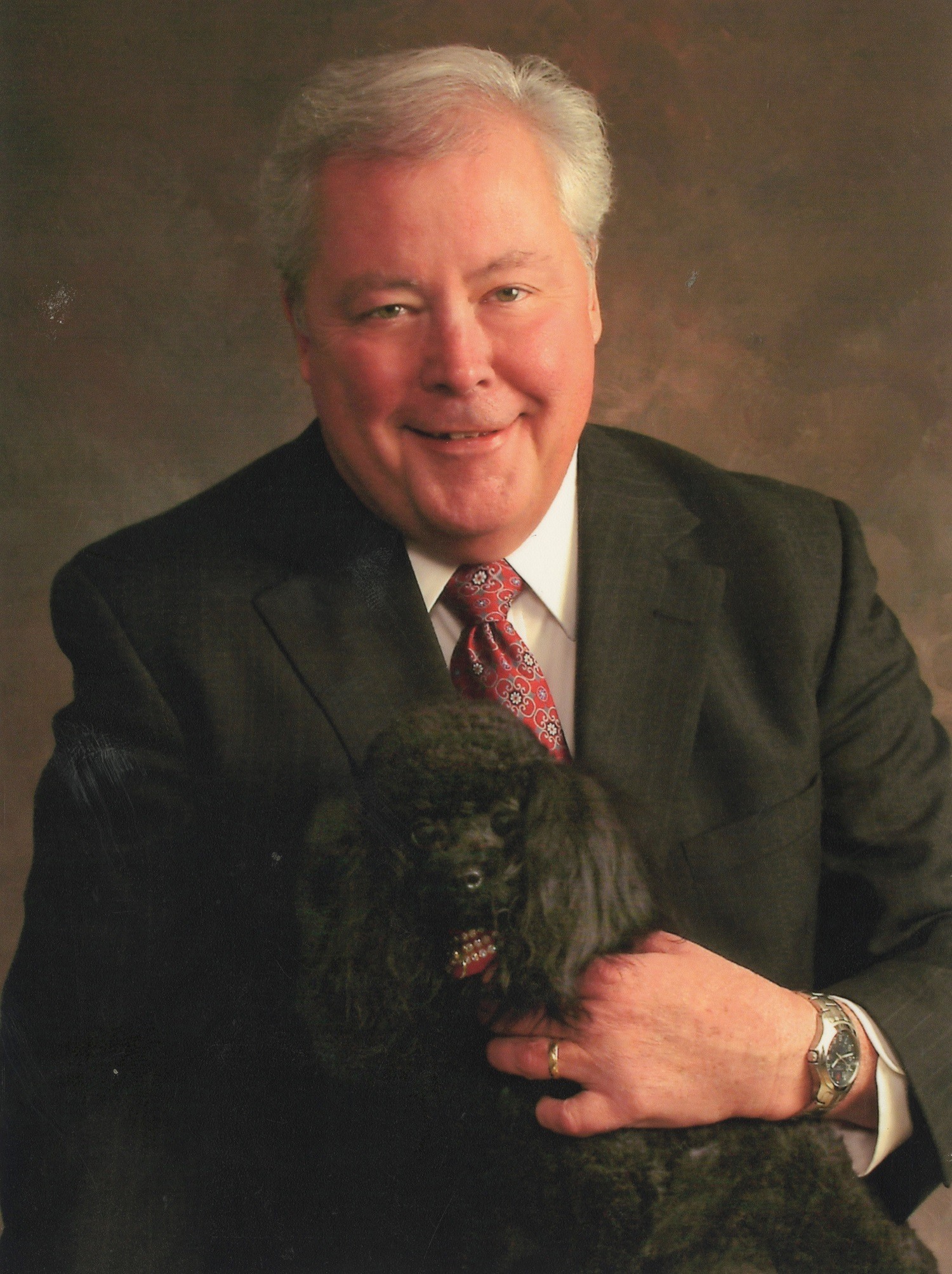 United Ability employee portrait with toy poodle