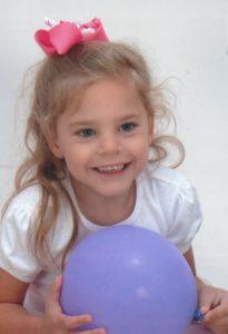Little girl holding a balloon