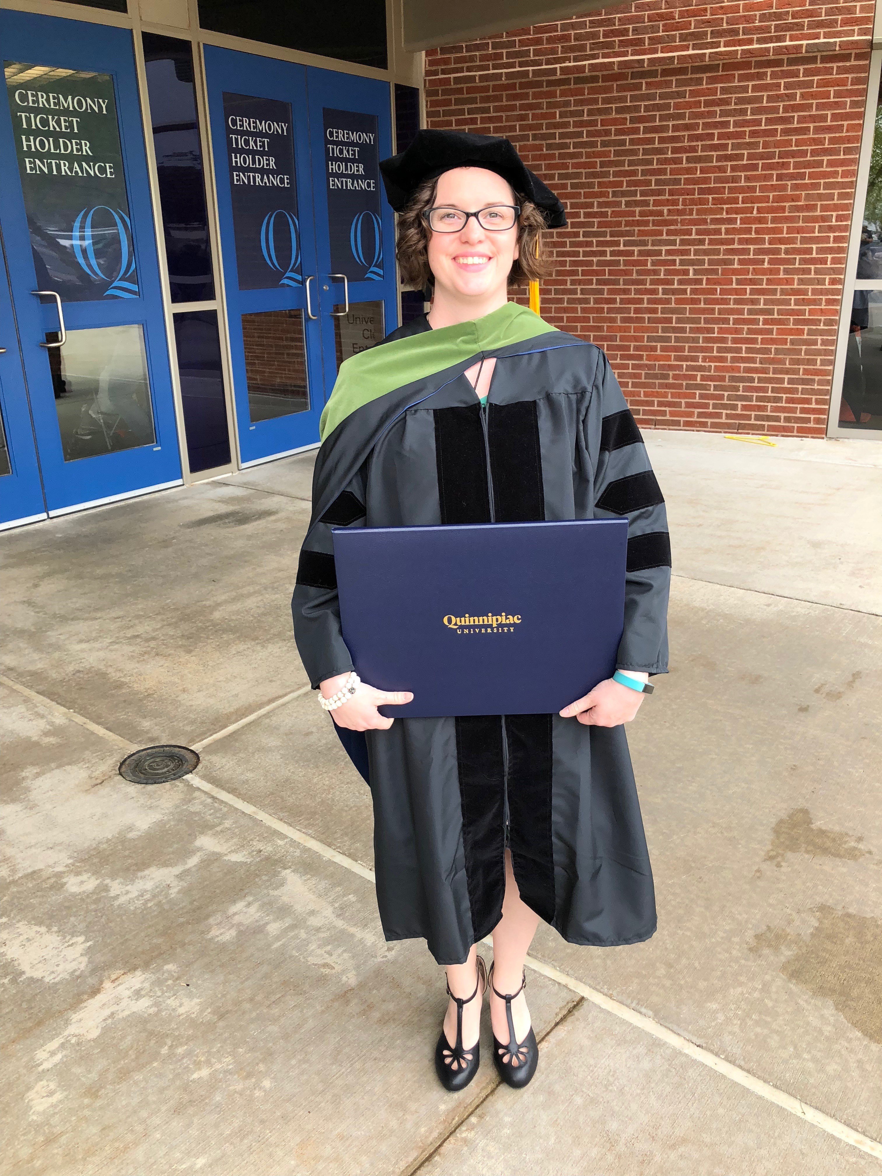 Woman graduating smiling with diploma
