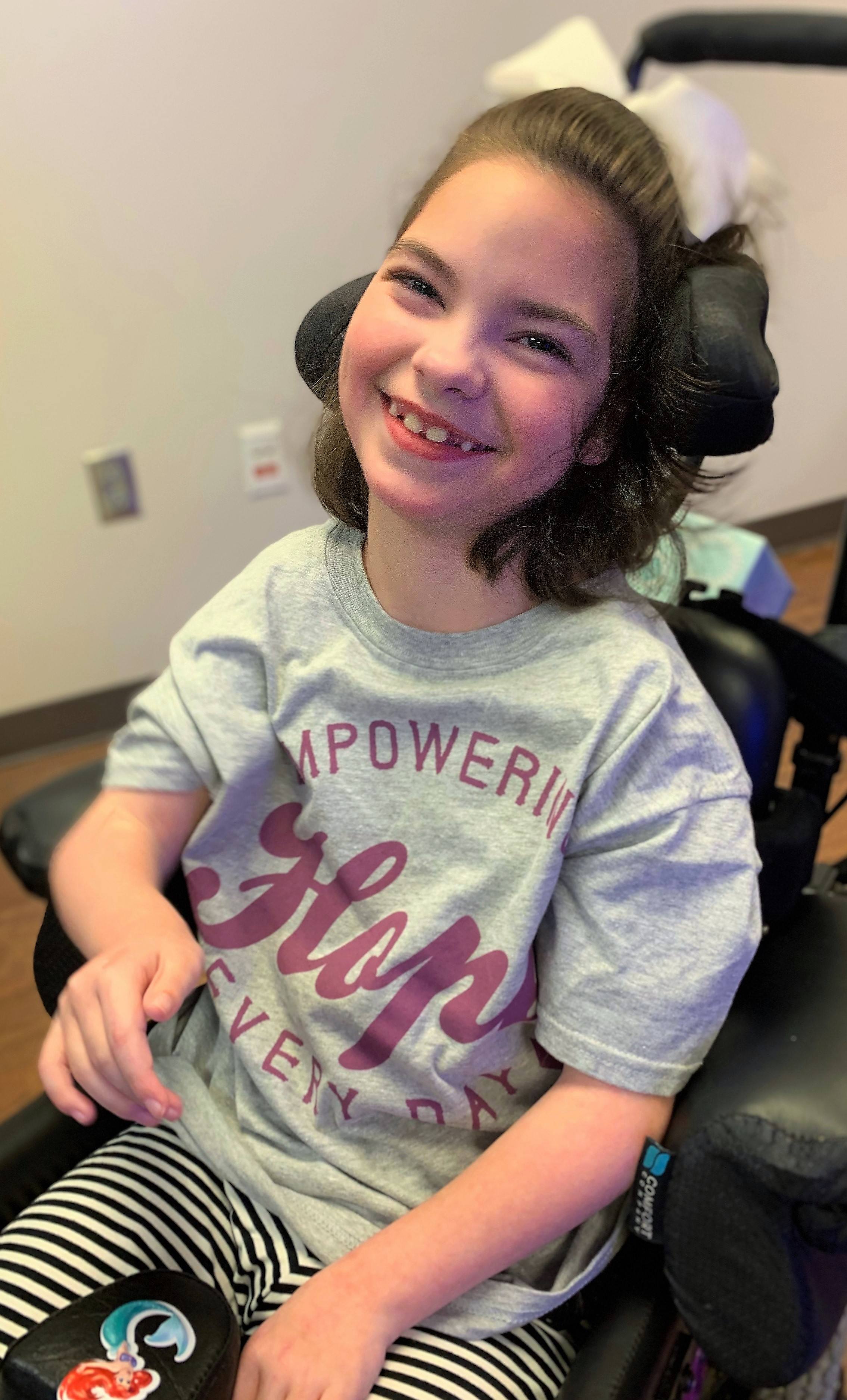 Little girl in wheelchair smiling